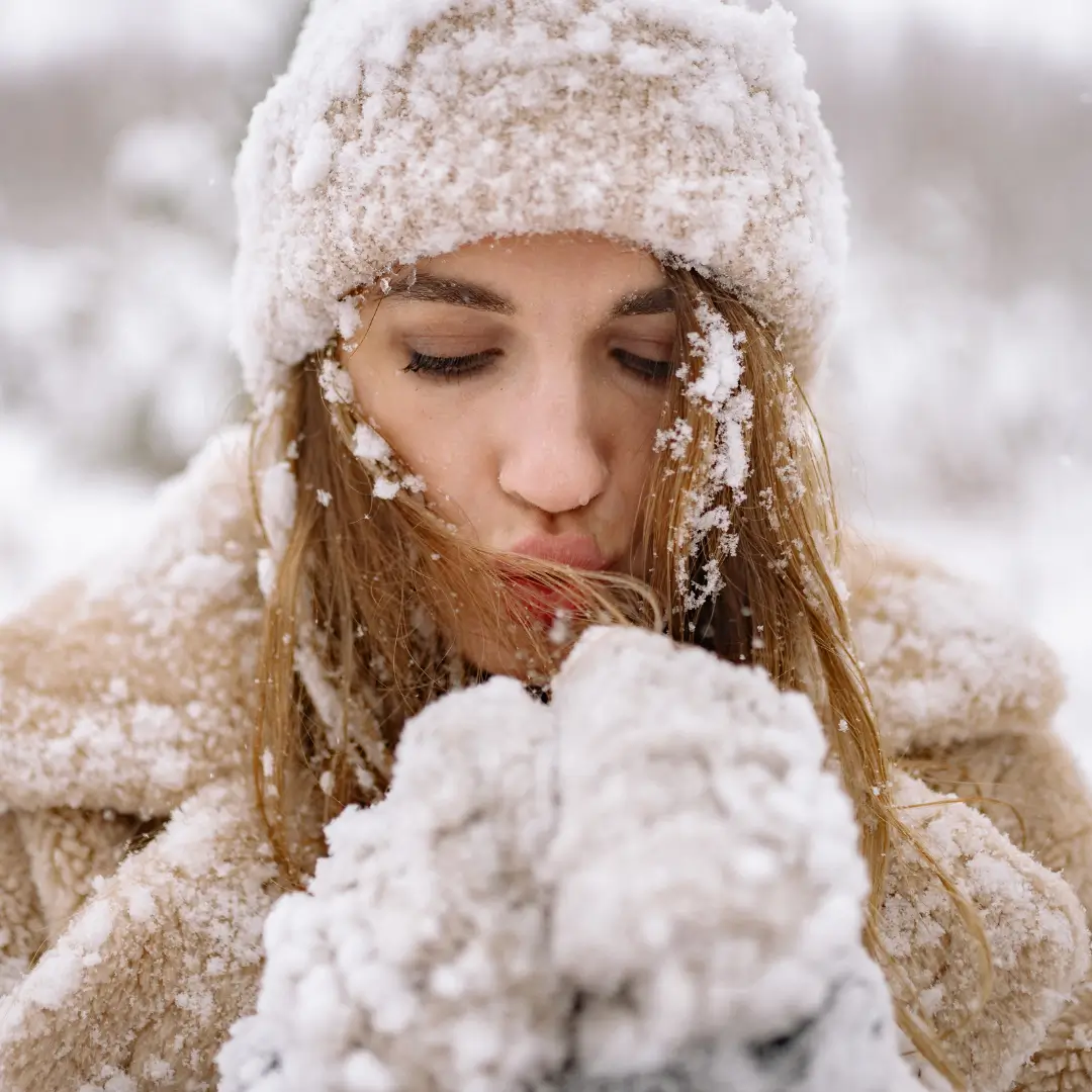 Close-Up Photo of Woman blowing Snow