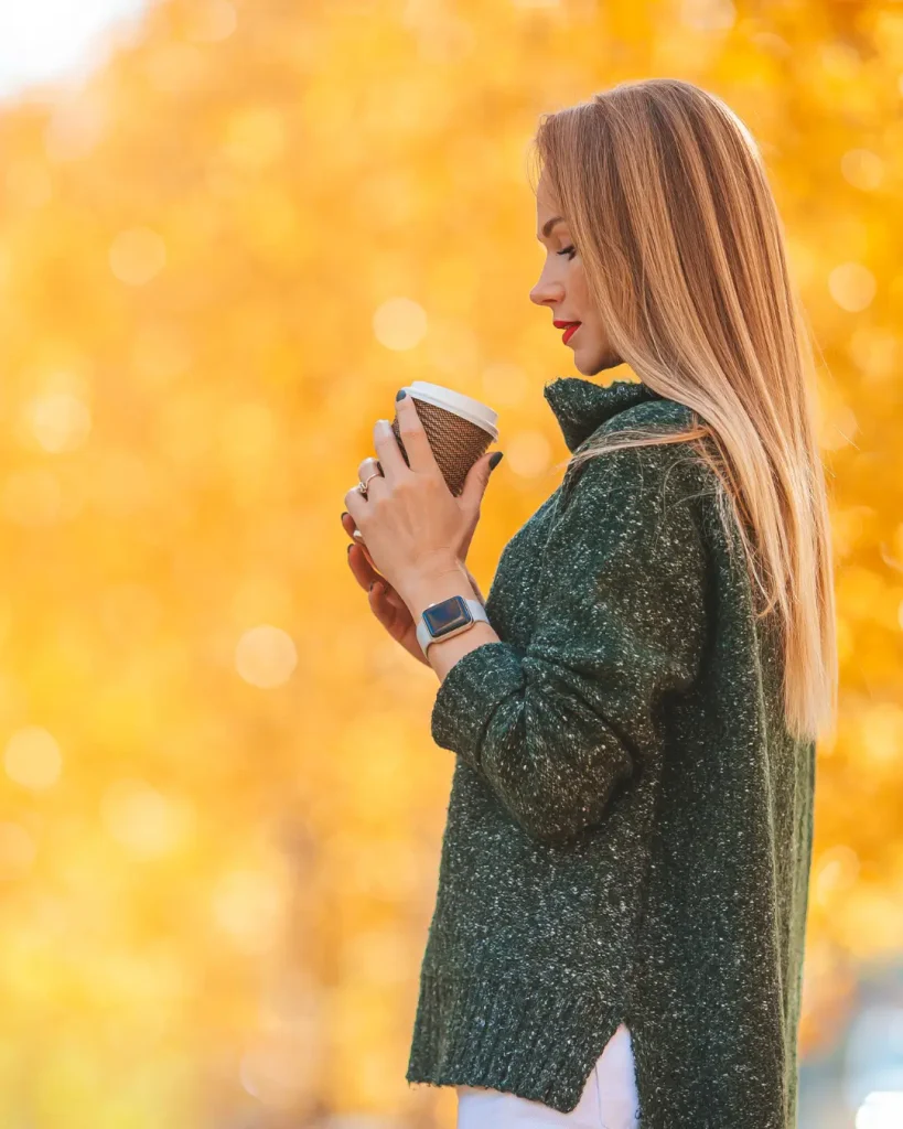 Fall Concept - Beautiful Woman Drinking Coffee in Autumn Park