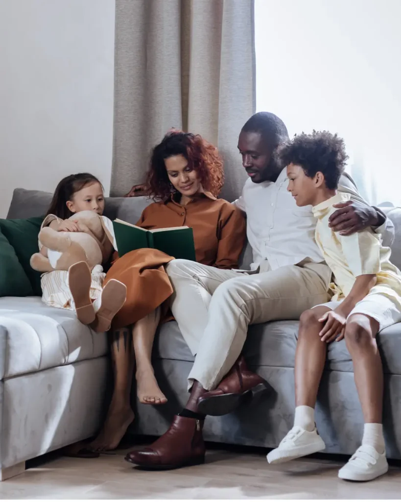 Family Sitting Together and Reading a Book