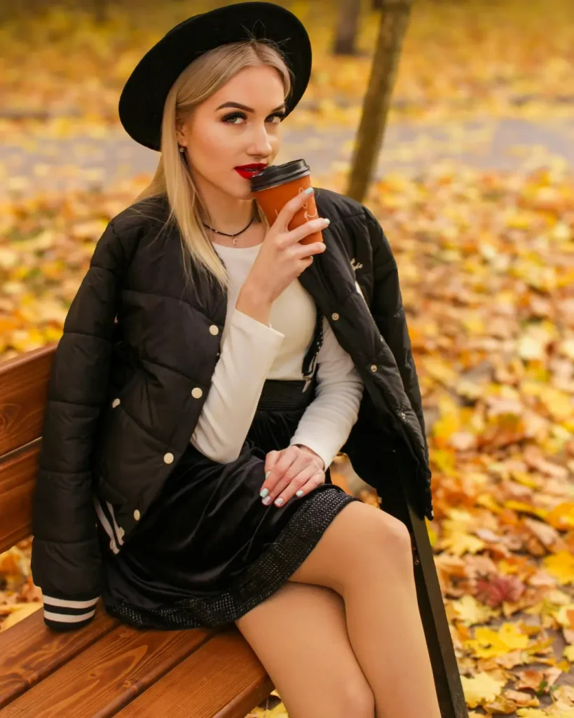Fashionable Woman Enjoying Coffee in Autumn Park