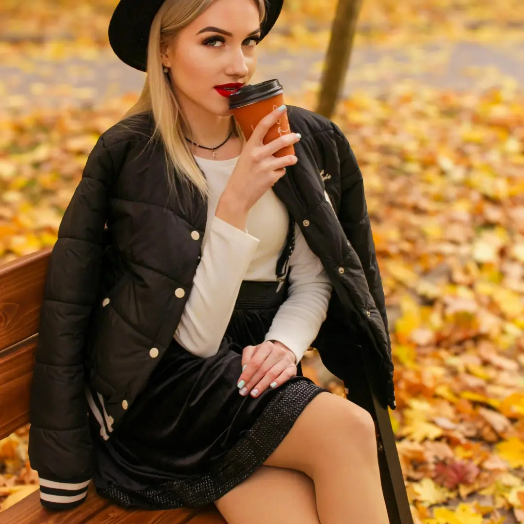 Fashionable Woman Enjoying Coffee in Autumn Park