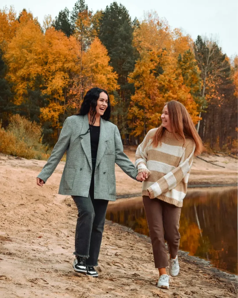 Happy Friends Walking by Autumn Lake