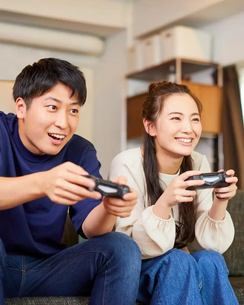 Joyful Young Couple Playing Video Games Together