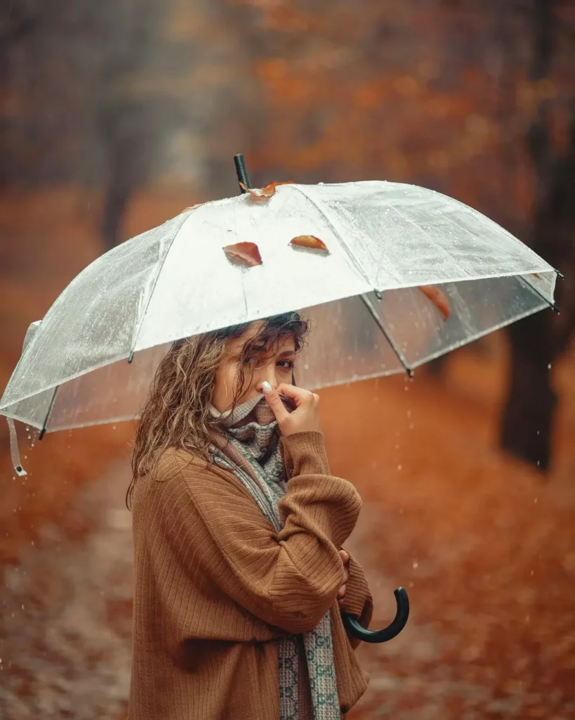 Woman with Umbrella in Autumn Rain