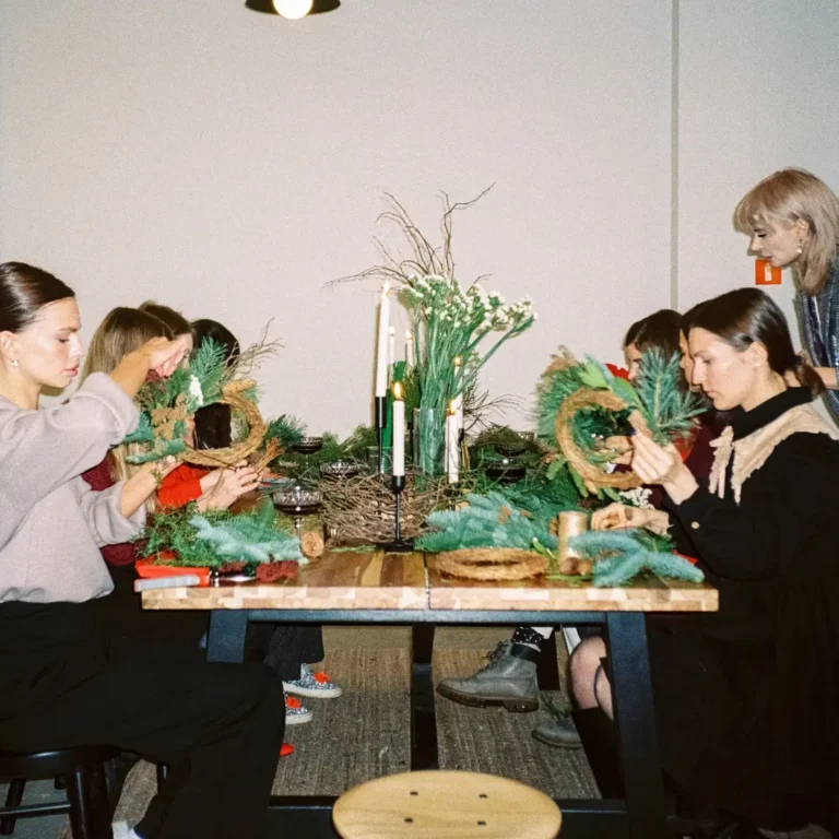 Women Preparing Christmas Wreaths at a Workshop