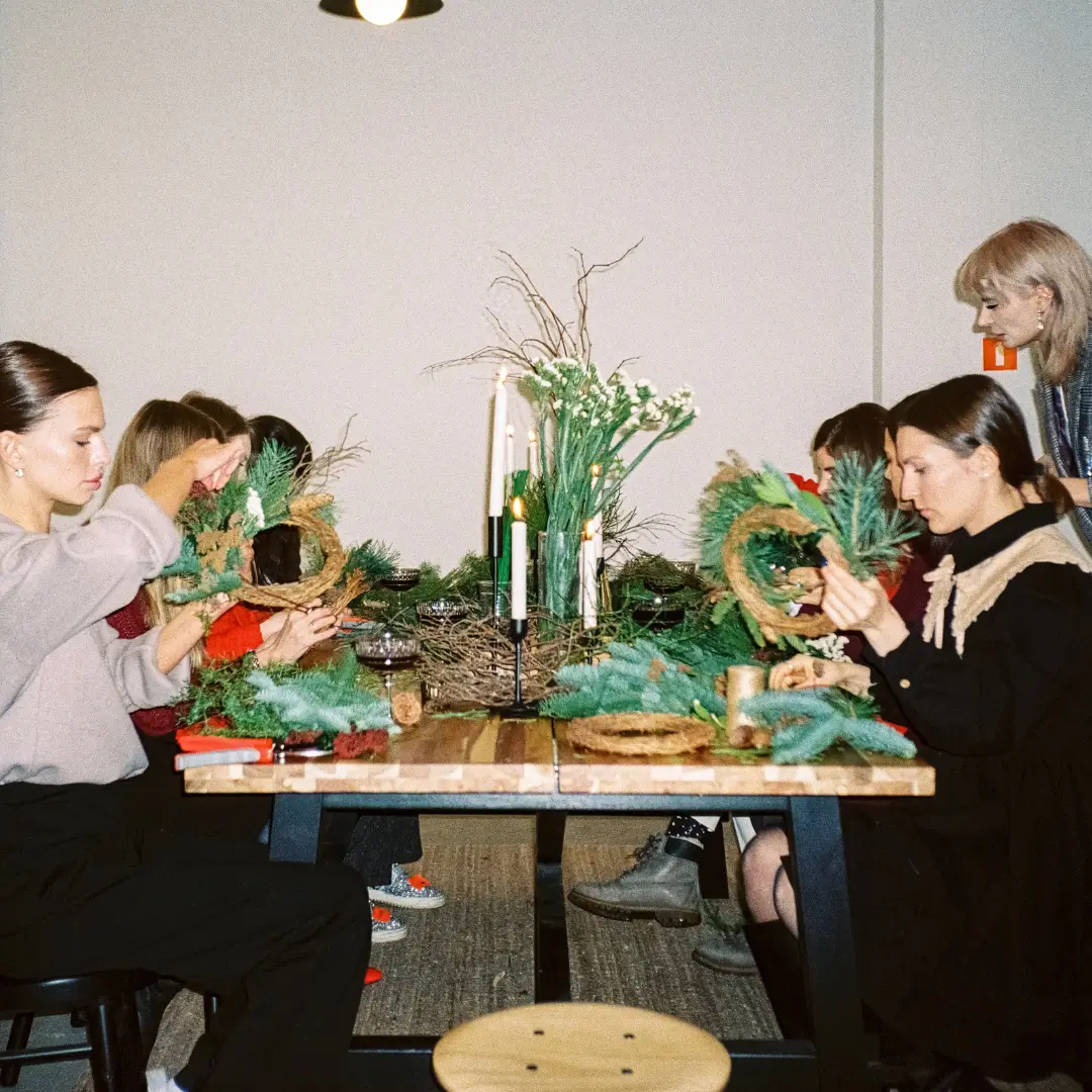 Women Preparing Christmas Wreaths at a Workshop
